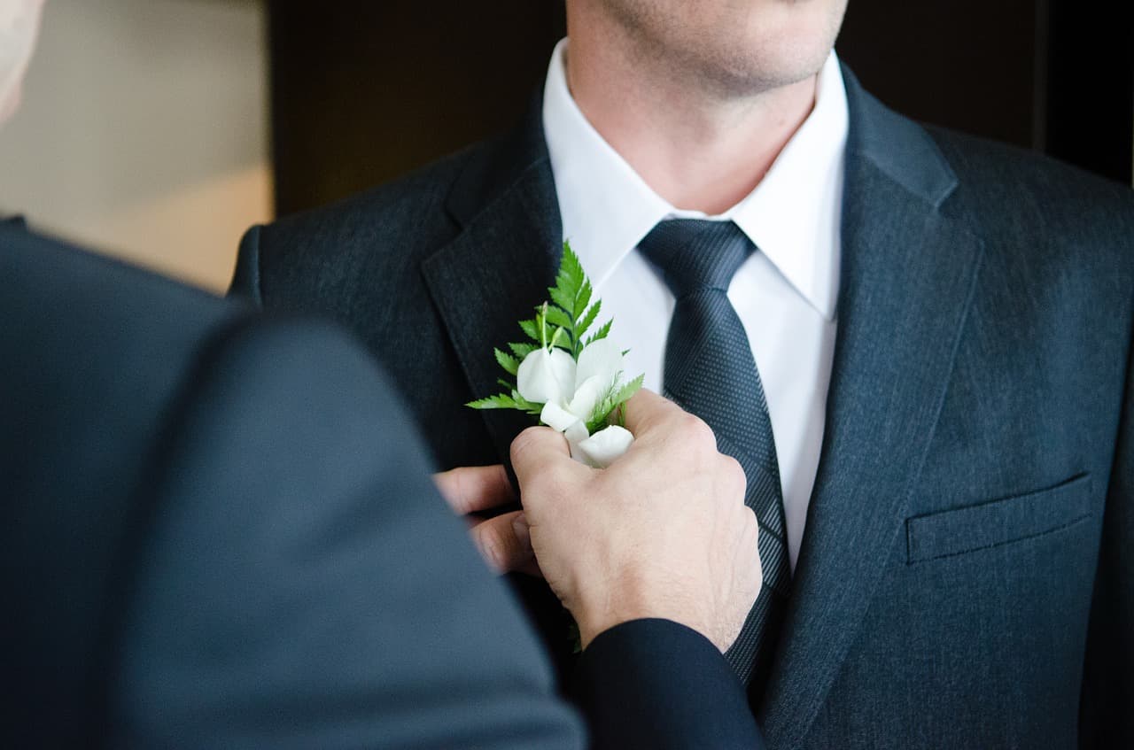 Boutonniere being pinned to a lapel
