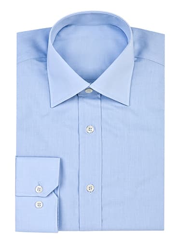 Folded light blue custom dress shirt with white buttons