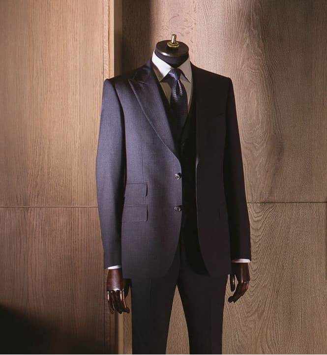 Finished navy three-piece suit displayed on a mannequin