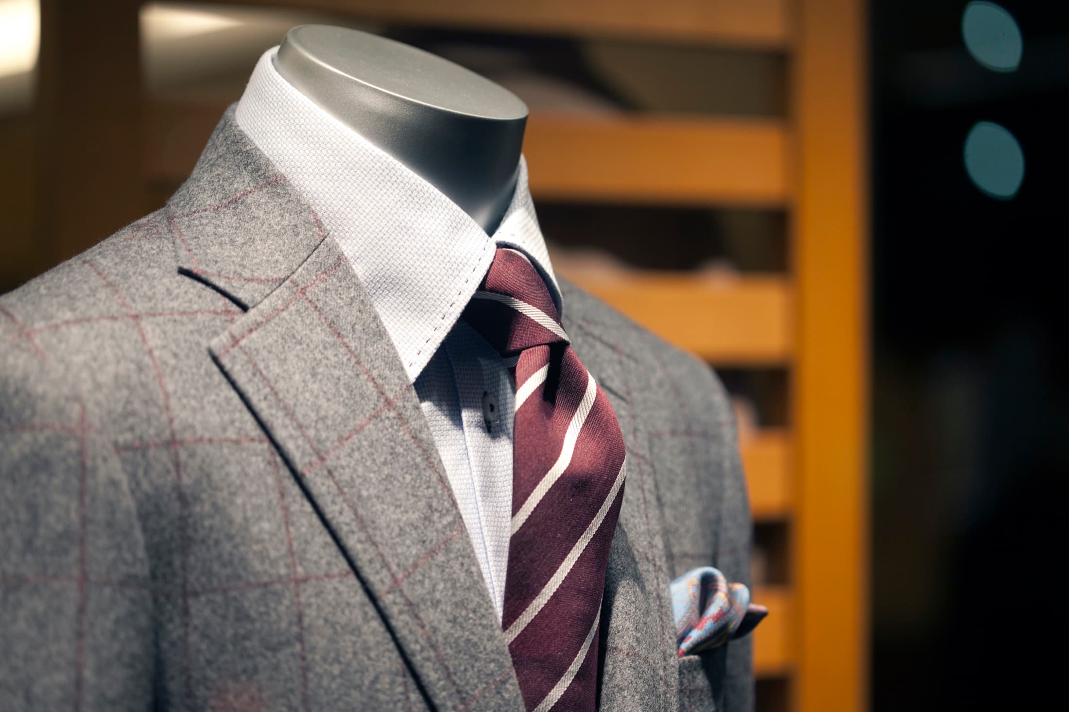 Tailor taking measurements on a jacket shoulder